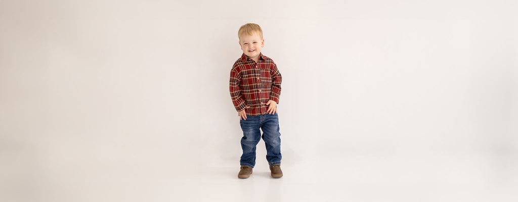 Boy wearing a woven plaid bottom-up top